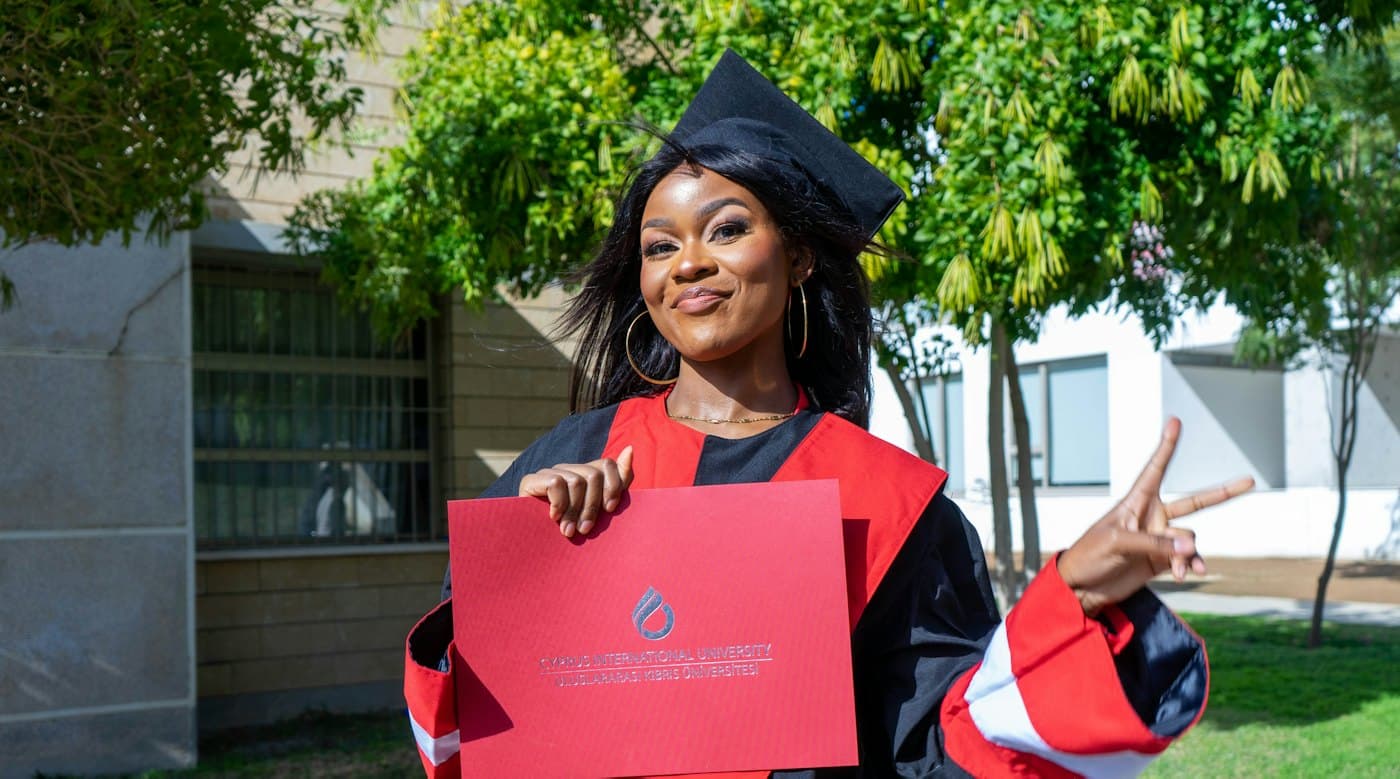 A graduate celebrating in her gown